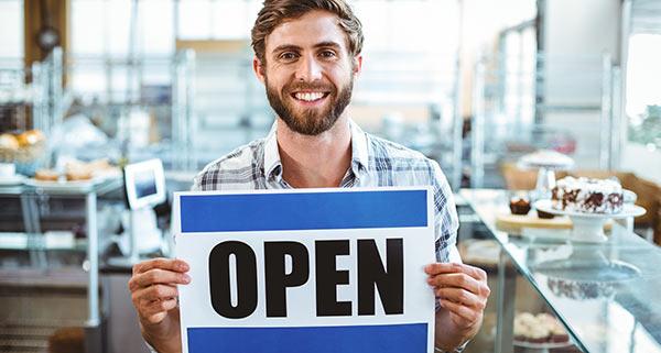 Man holding an open sign
